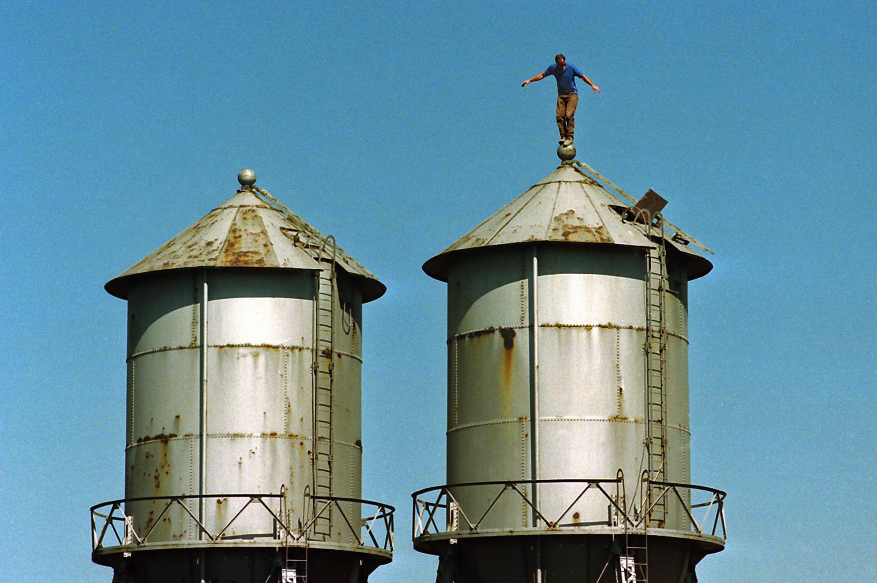 Bob Cassilly balances on water tank atop City Museum